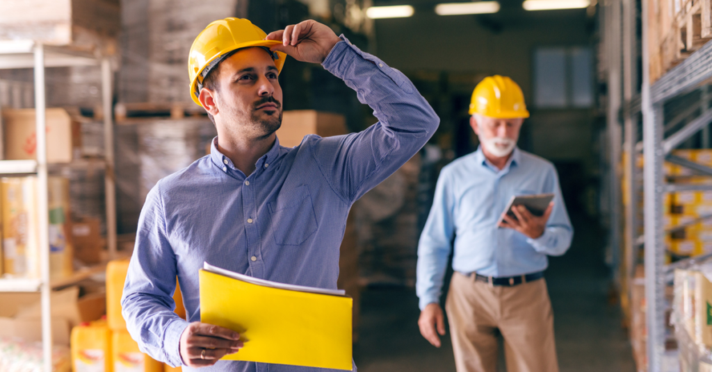 manufacturing boss with a yellow hard hat