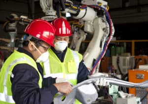 Manufacturing leader helping a team member 