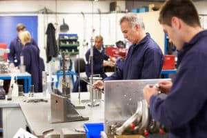 Busy Interior Of Engineering Workshop With Workers