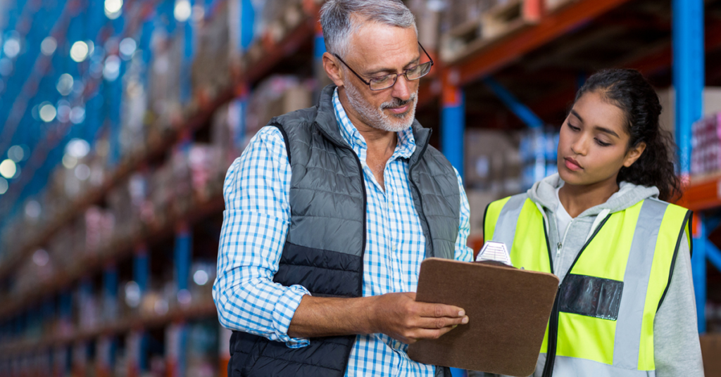 Manager talking to employee in warehouse