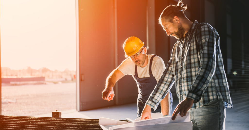 two factory workers building