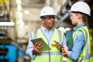 Two engineers discussing work and using tablet pc