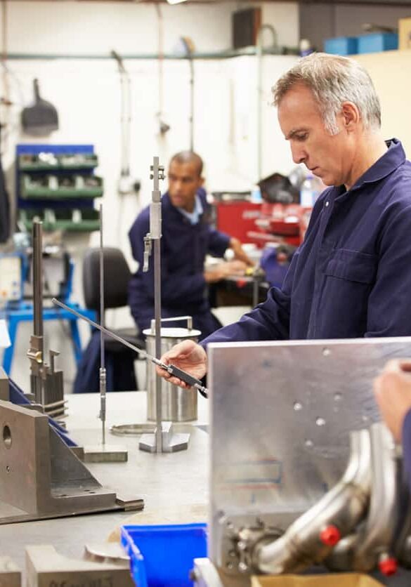 Busy Interior Of Engineering Workshop With Workers