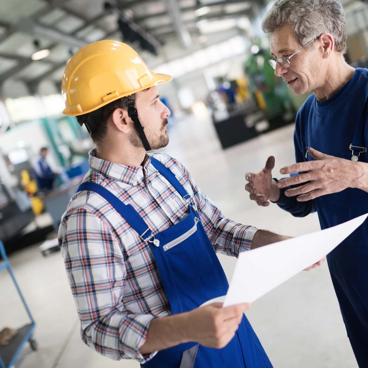 Portrait of an handsome engineer working in metal industry factory